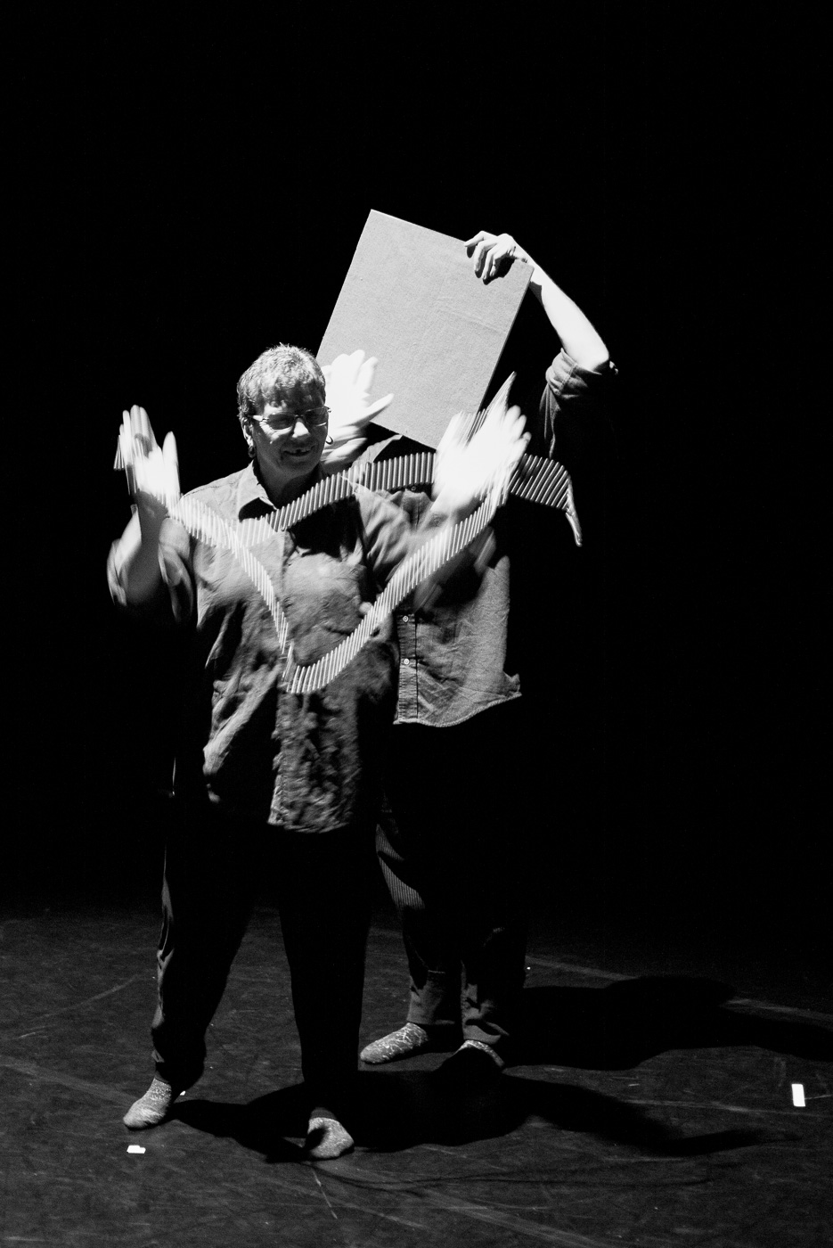 Black and white photo of Jackie dancing with beads in Adieu